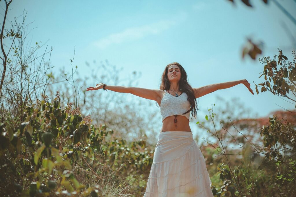 Peaceful scene of a woman meditating outdoors in a sunny summer setting, embodying wellness and tranquility.